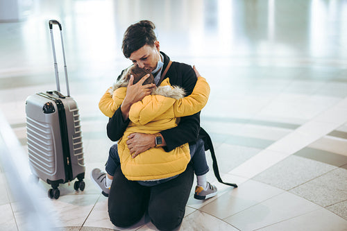 Mother hugging and kissing her child at airport