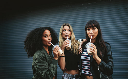 Multiracial group of women friends drinking coffee