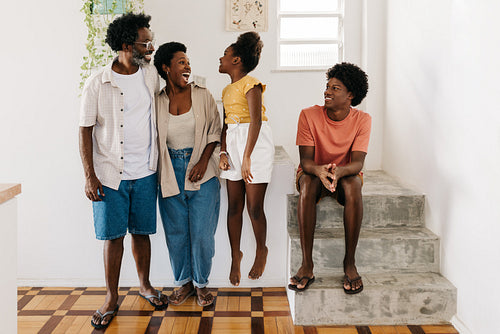 Daughter jumping and playing with her parents in a fun family moment