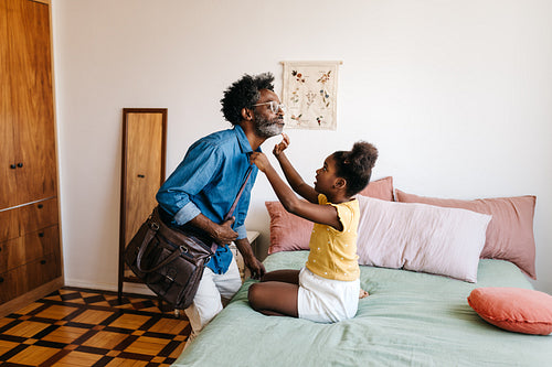 Daughter helping her dad get ready for the day