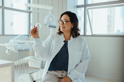 Dentist showcases dental aligner in bright clinic setting