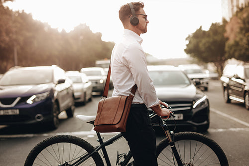Man crossing the road walking with his bicycle