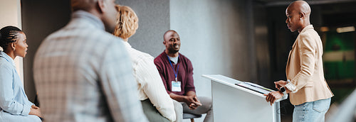 Professional businesswoman leading a colleague discussion in modern office setting