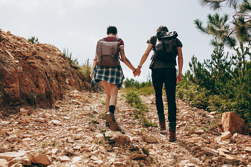 Explorer couple trekking a hill
