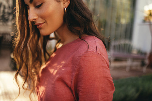 Pretty tourist woman standing alone outdoors