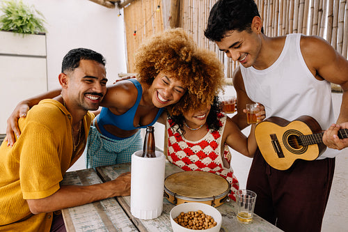 Friends enjoying a pagode gathering in Rio de Janeiro outdoors with instruments