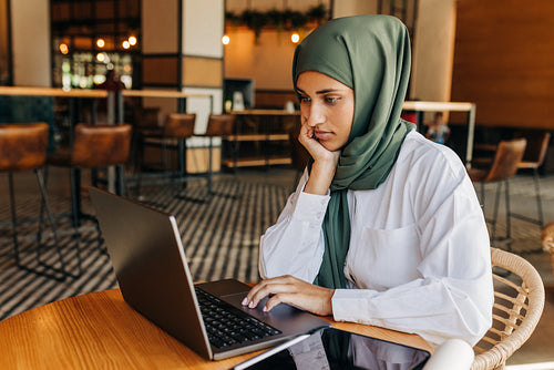 Muslim student studying in a cafe
