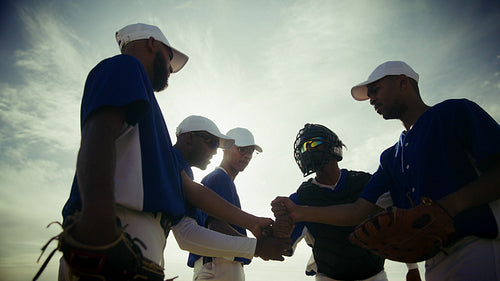 Baseball team huddles and runs on the field