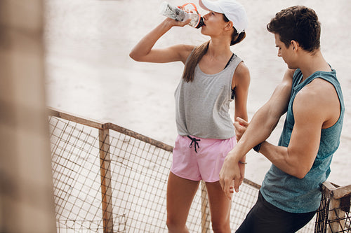 Young couple taking break after exercising