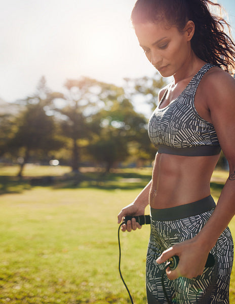Fitness woman with jump rope in a park