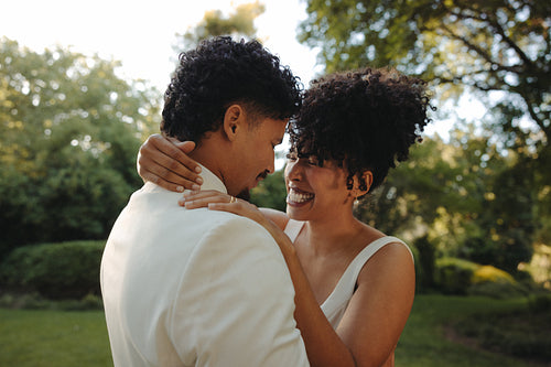 Bride and groom embracing beautifully in an outdoor garden setting