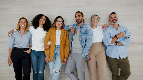 Achieving success together: Multicultural business team smiling at the camera in the office