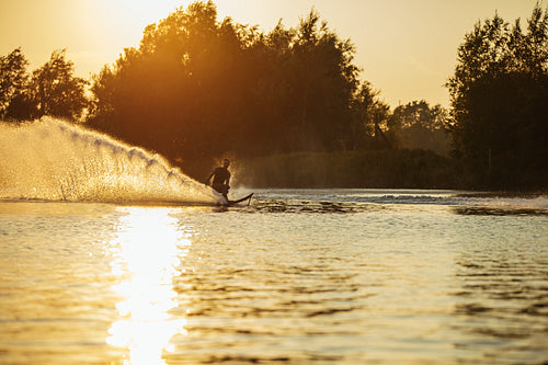 Man water skiing on lake