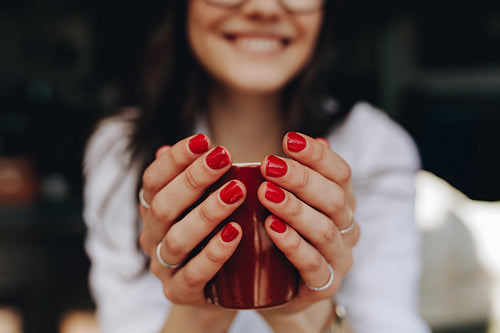 Woman hands holding a coffee cup