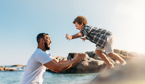 Father and son having fun at the beach