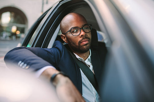 Businessman driving a car in city