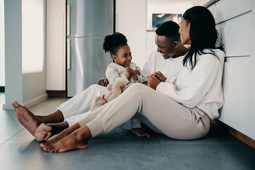 Couple bonding with their child at home