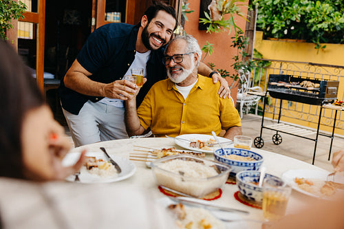 Latin father and son enjoying quality time during a barbecue event