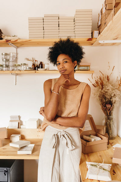 Thoughtful jewelry business owner in studio