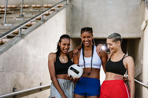 Woman soccer players with a ball at the stadium