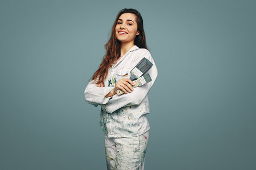 Female painter smiling at the camera in a studio