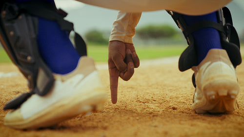 Catcher signals during a baseball game