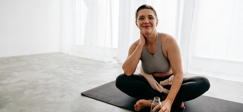 The yoga session shifts into a calm recovery moment at home on the mat