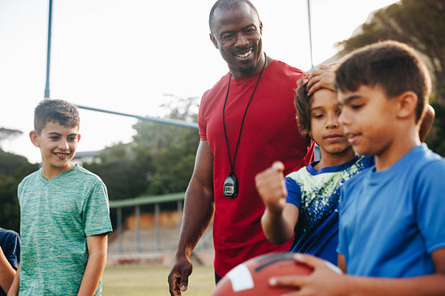 Coach training an elementary school rugby team