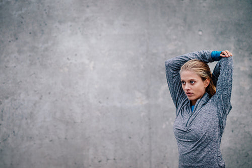 Female runner stretching arms after a running session