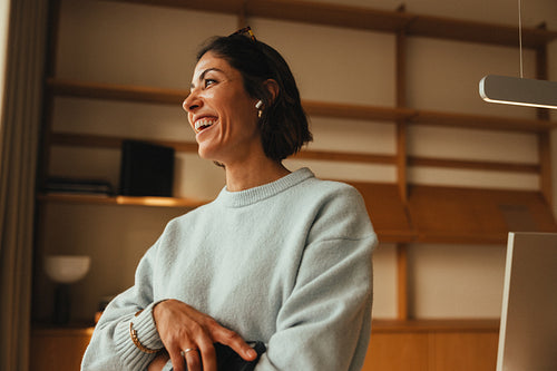 Smiling businesswoman poses in an office workspace