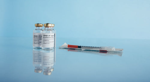 Covid-19 vaccine vials and syringe