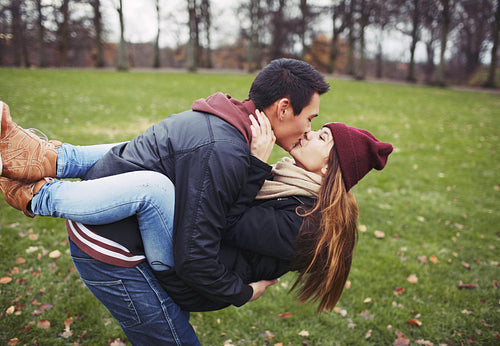 Sweet young couple sharing a kiss while out on a date