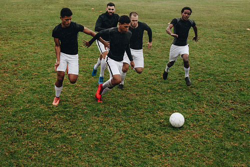 Men playing soccer on the field