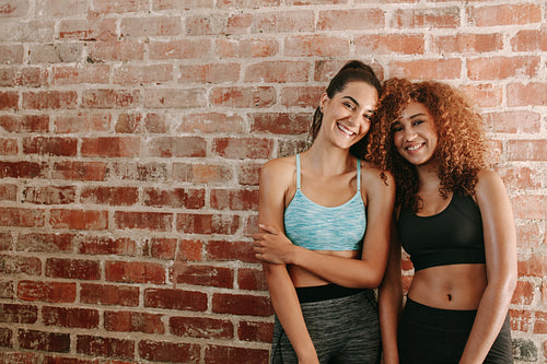 Two happy young women in sportswear