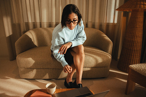 Businesswoman focused on laptop work in office