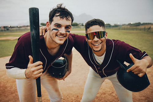 Two excited minor league baseball players celebrate on the field