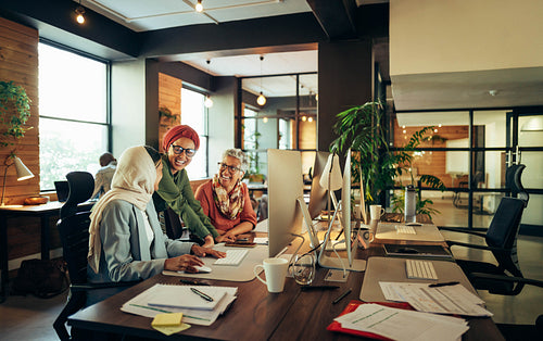Happy businesswomen working as a team in a coworking space