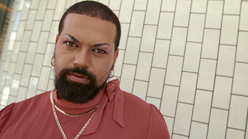 Gender fluid person in female clothes and makeup