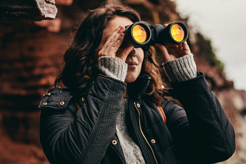Woman looking through binoculars