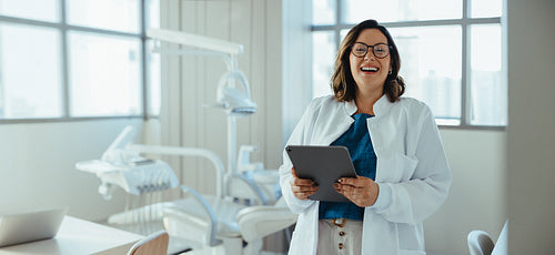 Her smile gives the dentist a warm and confident presence in the clinic