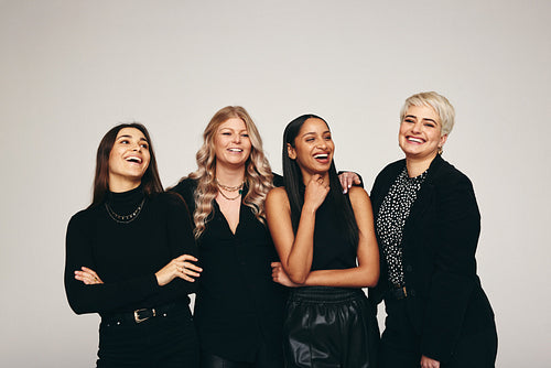 Strong group of women standing in a studio