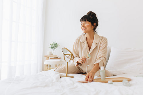 Woman doing facial massage at home