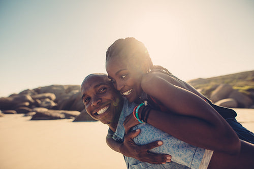 Young african couple enjoying at the beach
