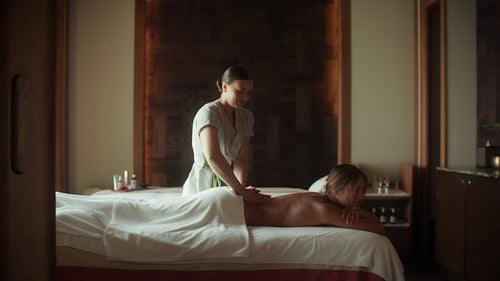 Woman enjoying a relaxing back massage at a luxurious resort spa