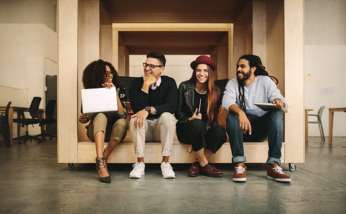 Business colleague talking sitting together in a wooden enclosure