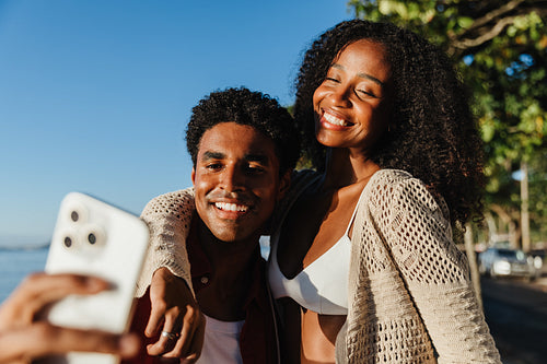 Young couple taking a selfie together in Brazil at sunset