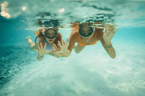 Family enjoying a holiday swimming in a clear ocean