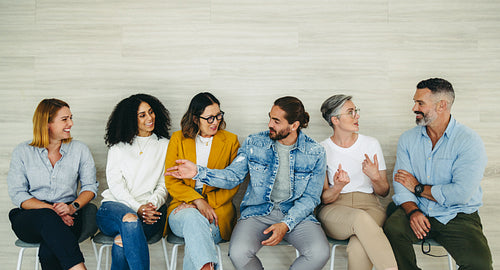 Happy businesspeople talking to each other before an interview