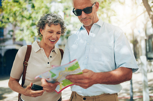 Couple using a map on vacation