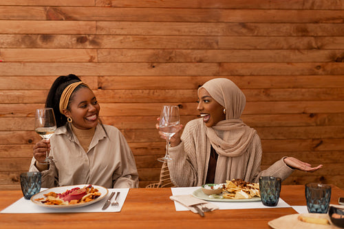 Friends enjoying a celebratory lunch in a restaurant